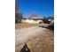 Charming single-story home with a long driveway and carport at 11301 Huggins St, Leesburg, FL 34788