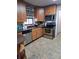 Well-appointed kitchen boasting stainless steel appliances and rich wood cabinetry at 11301 Huggins St, Leesburg, FL 34788