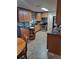Well-lit kitchen with wooden cabinetry, stainless steel appliances, and a built-in shelving unit at 11301 Huggins St, Leesburg, FL 34788