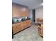 Spacious kitchen with ample counter space, wooden cabinets, and an adjacent dining area at 11301 Huggins St, Leesburg, FL 34788