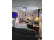 Comfortable living room features a ceiling fan, modern furniture, and a large TV at 11301 Huggins St, Leesburg, FL 34788