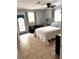 Bright bedroom featuring tile floors, a queen size bed, and a door to the backyard at 14545 Sw 34Th Terrace Rd, Ocala, FL 34473
