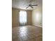 Unfurnished bedroom featuring tile flooring and a ceiling fan at 14545 Sw 34Th Terrace Rd, Ocala, FL 34473