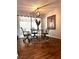 Bright dining area with modern chandelier, seating for four, and large windows at 14545 Sw 34Th Terrace Rd, Ocala, FL 34473