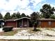 Exterior of a lovely home with tidy landscaping, mature trees, and a peaceful suburban setting at 14545 Sw 34Th Terrace Rd, Ocala, FL 34473