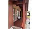 Inviting covered front porch with bench, brick facade, and decorative columns at 14545 Sw 34Th Terrace Rd, Ocala, FL 34473