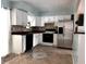 Clean kitchen featuring white cabinetry, stainless steel appliances, and durable tile flooring at 14545 Sw 34Th Terrace Rd, Ocala, FL 34473