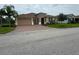 Charming single-story home with a two-car garage, brick driveway, and well-manicured lawn at 803 Jasmine Creek Rd, Kissimmee, FL 34759