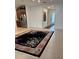 Open-concept living room with tile floors, an oriental rug, and views of the kitchen at 803 Jasmine Creek Rd, Kissimmee, FL 34759