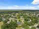 Charming neighborhood surrounded by trees and nature, under a blue sky with scattered clouds at 8929 Sw 196Th Ct, Dunnellon, FL 34432