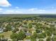Sprawling neighborhood nestled amongst lush greenery and trees beneath a blue sky with scattered clouds at 8929 Sw 196Th Ct, Dunnellon, FL 34432