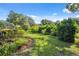Well-maintained backyard with mature trees and lush greenery at 8929 Sw 196Th Ct, Dunnellon, FL 34432