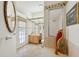 Bathroom with a soaking tub, vanity, and door to the outside at 8929 Sw 196Th Ct, Dunnellon, FL 34432