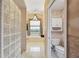 Well-lit bathroom with tiled floors, a large soaking tub, and a separate toilet room at 8929 Sw 196Th Ct, Dunnellon, FL 34432