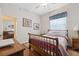 Bedroom featuring a bed with wooden frame, wood floors, and natural light at 8929 Sw 196Th Ct, Dunnellon, FL 34432