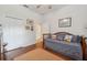 Well-lit bedroom featuring wooden furniture, wood floors, and natural light at 8929 Sw 196Th Ct, Dunnellon, FL 34432