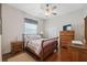 Cozy bedroom with wood furniture, ceiling fan, and a double door closet at 8929 Sw 196Th Ct, Dunnellon, FL 34432