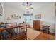Bedroom featuring wooden furniture, a ceiling fan, and natural light at 8929 Sw 196Th Ct, Dunnellon, FL 34432