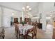 Bright dining area with decorative chandelier and arched doorway to a large living space at 8929 Sw 196Th Ct, Dunnellon, FL 34432