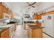 Well-lit kitchen with wooden cabinets, granite counters, stainless steel appliances, and an island at 8929 Sw 196Th Ct, Dunnellon, FL 34432