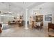 Open-concept living and dining room features soaring ceilings, a decorative pillar, and tile flooring at 8929 Sw 196Th Ct, Dunnellon, FL 34432
