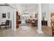 Open-concept living room with tall ceilings, tile flooring, a decorative pillar, and French doors to the outdoor space at 8929 Sw 196Th Ct, Dunnellon, FL 34432