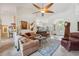 Spacious living room boasts lots of natural light, high ceilings, and a decorative ceiling fan at 8929 Sw 196Th Ct, Dunnellon, FL 34432