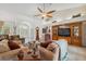 Spacious living area with soaring ceilings, a classic grandfather clock, and a built-in entertainment center at 8929 Sw 196Th Ct, Dunnellon, FL 34432