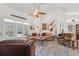 Comfortable living room featuring soaring ceilings, French doors to a patio, and eclectic wall décor with guitars and artwork at 8929 Sw 196Th Ct, Dunnellon, FL 34432