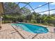 Refreshing screened-in pool and spa surrounded by lush landscaping offer a private retreat at 8929 Sw 196Th Ct, Dunnellon, FL 34432