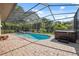Sparkling screened-in pool with brick surround and relaxing hot tub, perfect for outdoor enjoyment at 8929 Sw 196Th Ct, Dunnellon, FL 34432