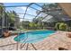 Beautiful in-ground pool and spa area with brick border and screened in enclosure at 8929 Sw 196Th Ct, Dunnellon, FL 34432