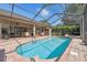 Bask in the sun by the beautiful pool, enhanced by a screened enclosure and brick pavers at 8929 Sw 196Th Ct, Dunnellon, FL 34432
