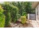 Landscaped side yard area features brick pavers, lush plantings, and a gated entrance at 8929 Sw 196Th Ct, Dunnellon, FL 34432