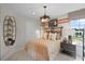 Cozy bedroom featuring a comfortable bed, stylish lighting fixture, and decorative shelving at 1125 Red Buckeye Ct, Deland, FL 32720