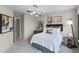 Inviting bedroom with bed, decorative pillows, study desk, and stylish light fixture at 1125 Red Buckeye Ct, Deland, FL 32720