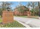 Attractive exterior of a historical building with a brick entrance sign and flourishing landscaping at 1125 Red Buckeye Ct, Deland, FL 32720