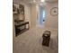 Hallway with neutral walls, carpet and decorations with a dark wooden console table with an abstract painting above it at 1125 Red Buckeye Ct, Deland, FL 32720