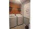 Well-equipped laundry area featuring modern washer and dryer units, plus shelving for linens and laundry necessities at 1125 Red Buckeye Ct, Deland, FL 32720