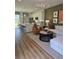 Open-concept living room with modern decor, neutral tones, and an adjoining kitchen for seamless entertaining at 1125 Red Buckeye Ct, Deland, FL 32720