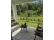 Relaxing outdoor patio with comfortable seating and views of the lush green lawn and landscaping, perfect for enjoying nature at 1125 Red Buckeye Ct, Deland, FL 32720