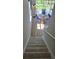 Carpeted staircase leading to a bright patio with table and chairs, offering scenic views and relaxation at 1125 Red Buckeye Ct, Deland, FL 32720