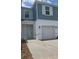 Charming two-story townhome with a one car garage and landscaped front yard at 1129 Red Buckeye Ct, Deland, FL 32720