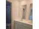 Bathroom featuring a double-sink vanity and walk-in shower with gray tile at 1133 Red Buckeye Ct, Deland, FL 32720