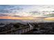 A boardwalk leads to a sandy beach and calm ocean under a dawn sky at 1133 Red Buckeye Ct, Deland, FL 32720