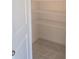 Walk in closet with metal shelving and tile flooring, providing ample storage space at 1133 Red Buckeye Ct, Deland, FL 32720