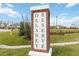 Delaney Park community entrance sign made of brick and white trim surrounded by green lawns, landscaping, and trees at 1133 Red Buckeye Ct, Deland, FL 32720