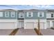 Charming townhome exterior showcases light blue siding and a well-manicured lawn at 1133 Red Buckeye Ct, Deland, FL 32720