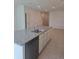 Kitchen island with granite countertop, stainless steel sink and appliances in an open floorplan at 1133 Red Buckeye Ct, Deland, FL 32720