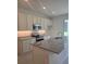 Well lit kitchen with granite countertops, stainless steel appliances, and ample cabinet space at 1133 Red Buckeye Ct, Deland, FL 32720